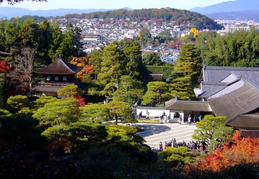Ginkaku-ji and its garden seen from the hillside path in autumn, with Kyoto behind