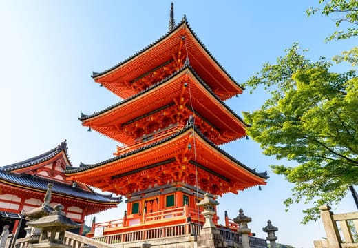 The vermilion three-storey pagoda of Kiyomizu-dera under a blue sky
