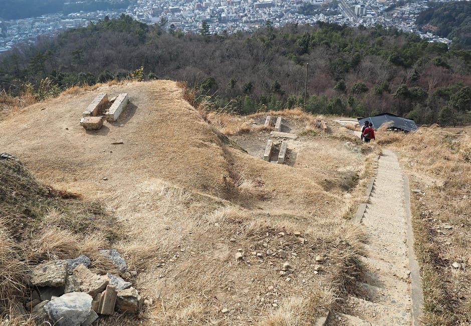 Stone fire beds and steps at the top of the Daimonji-yama 大 character, with Kyoto spread out below