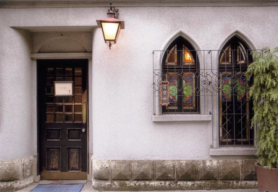 The white facade and stained glass windows of the Francois coffee house in Kyoto