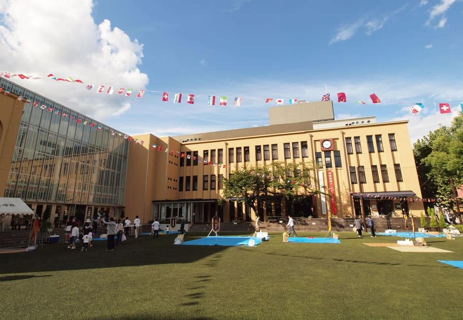 The former school building of the Kyoto International Manga Museum behind its lawn