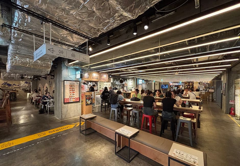 Counters and shared tables in the basement food hall of Kyoto Tower Sando